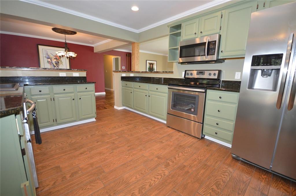 2610 Pulaski Road New Castle, PA 16105 - Photo 9 of 25 Brand new, never before used refrigerator and electric stove are ready and waiting for you. Microwave replaced in 2017. Lots of counter space and bar counter make food prep and serving simple.