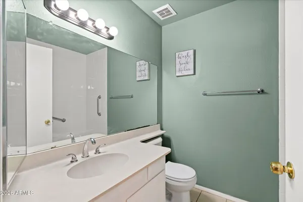 a bathroom with a sink toilet and a mirror