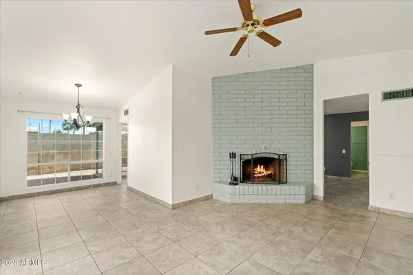 a view of a livingroom with a fireplace and window
