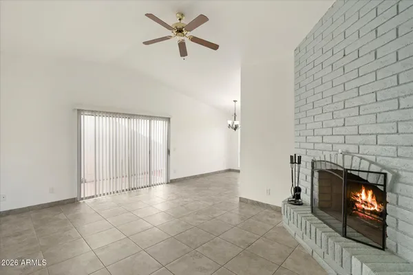 an empty room with fireplace and fan