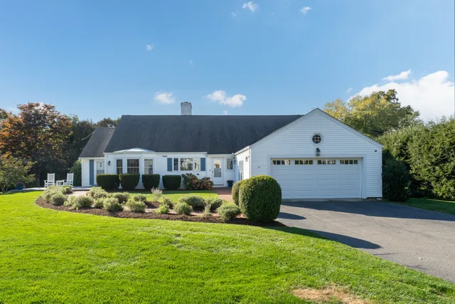 a front view of house with yard and green space