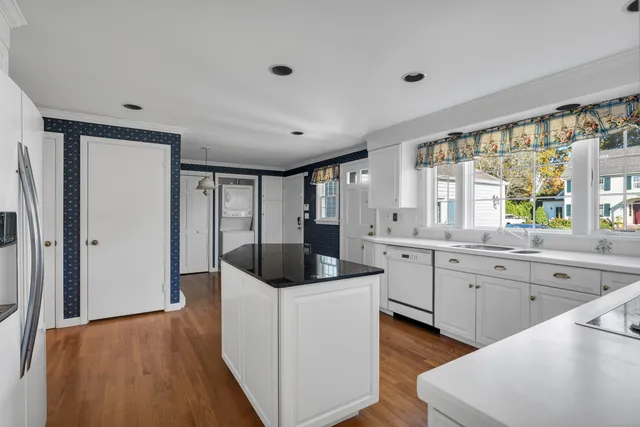 a kitchen with a stove a sink and a refrigerator