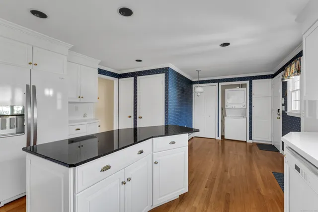 a spacious bathroom with a granite countertop sink mirror and shower