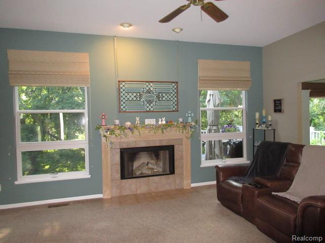 11356 Tall Shadows Court Pinckney, MI 48169 - Photo 11 of 29 Living area featuring a tiled fireplace with mantel,