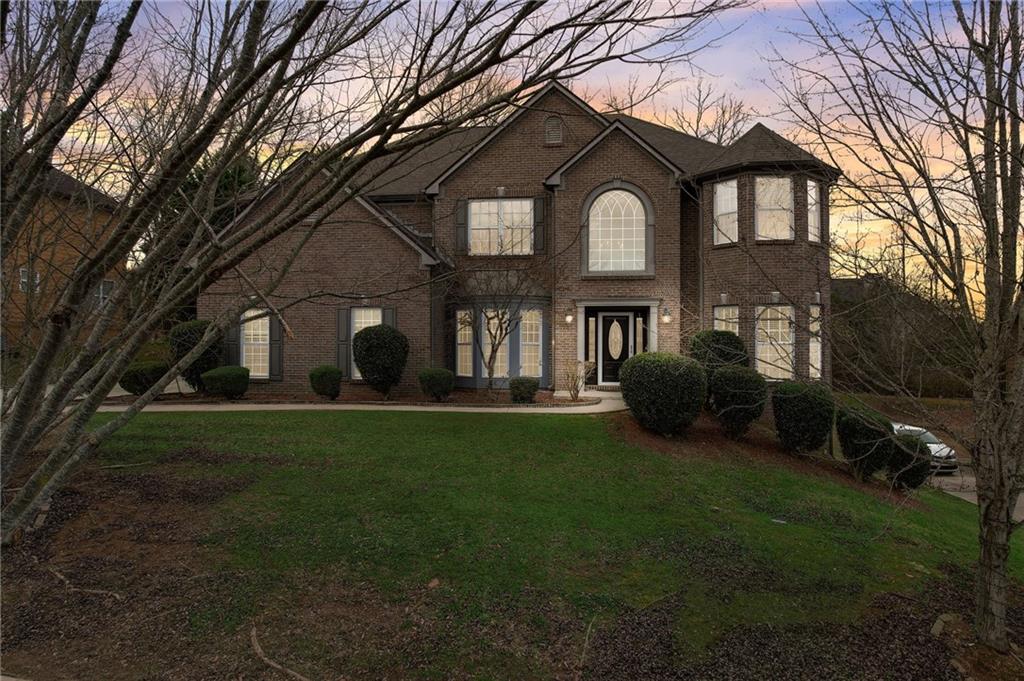 a front view of a house with a garden