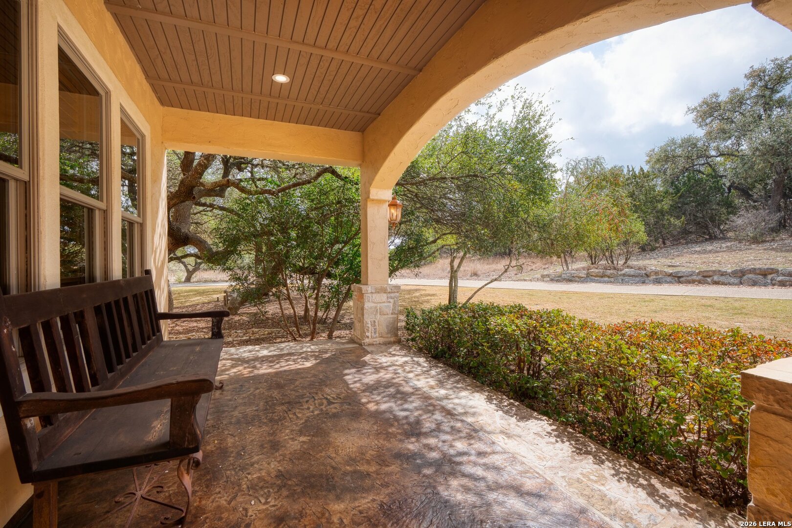 136 Park Ridge Boerne, TX 78006 - Photo 36 of 47 a view of a patio with lawn chairs floor to ceiling window and wooden fence