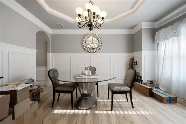 a view of a dining room with furniture and chandelier