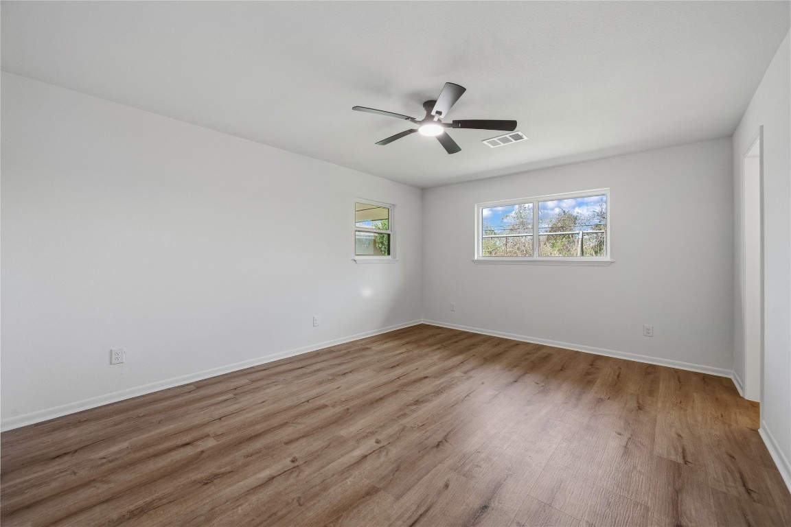 210 Ridgemont Drive Alvin, TX 77511 - Photo 14 of 25 a view of empty room with wooden floor and fan