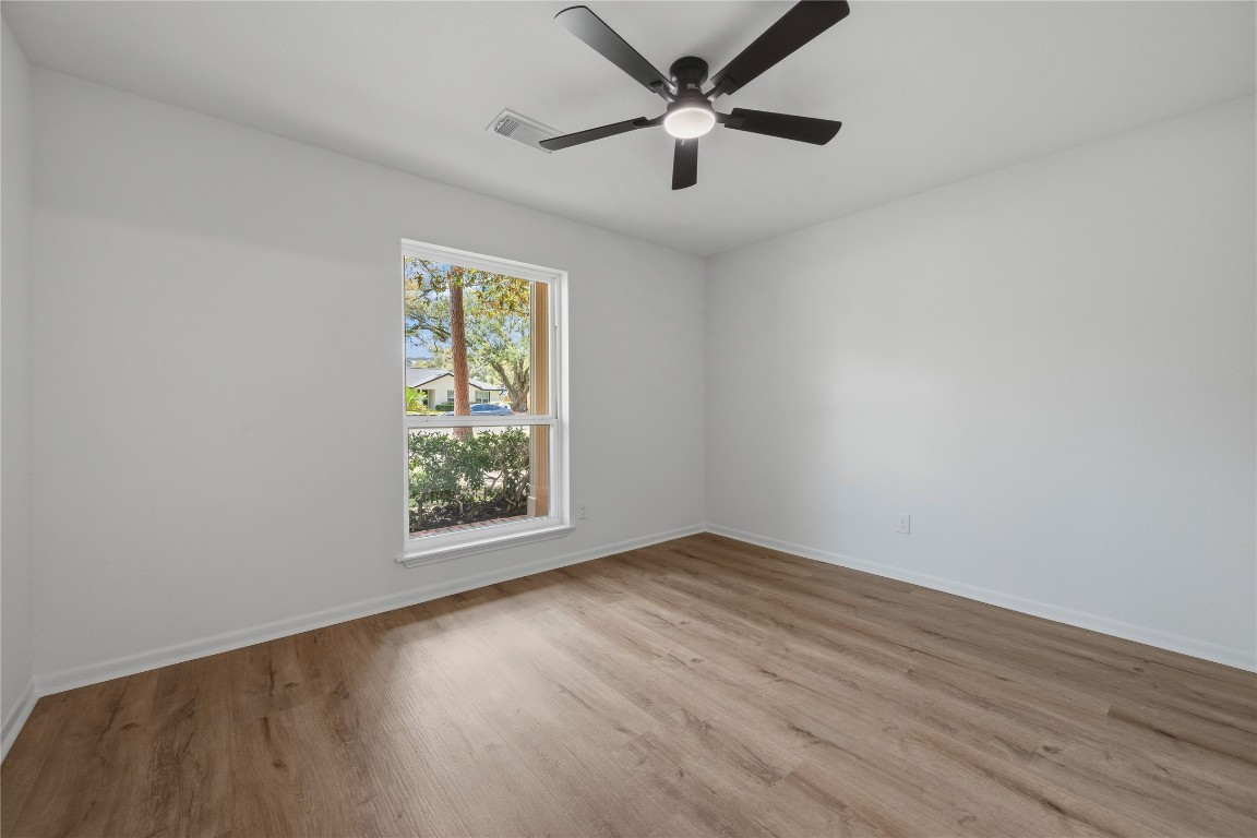 210 Ridgemont Drive Alvin, TX 77511 - Photo 16 of 25 an empty room with wooden floor and windows