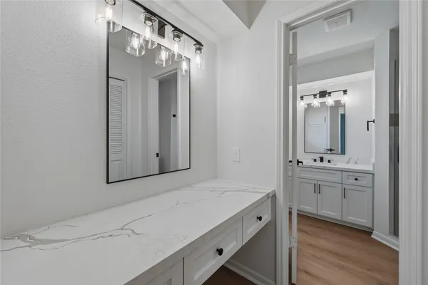 a bathroom with a double vanity sink mirror and shower