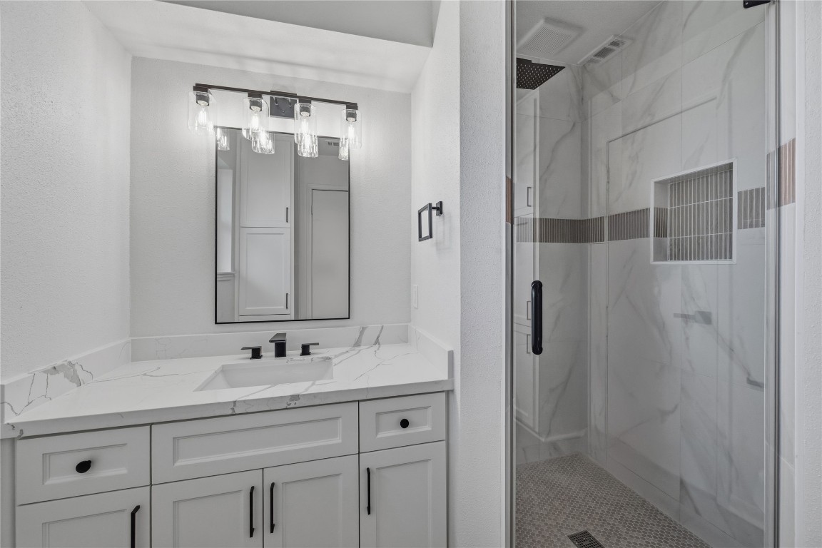 210 Ridgemont Drive Alvin, TX 77511 - Photo 18 of 25 a bathroom with a shower sink and mirror