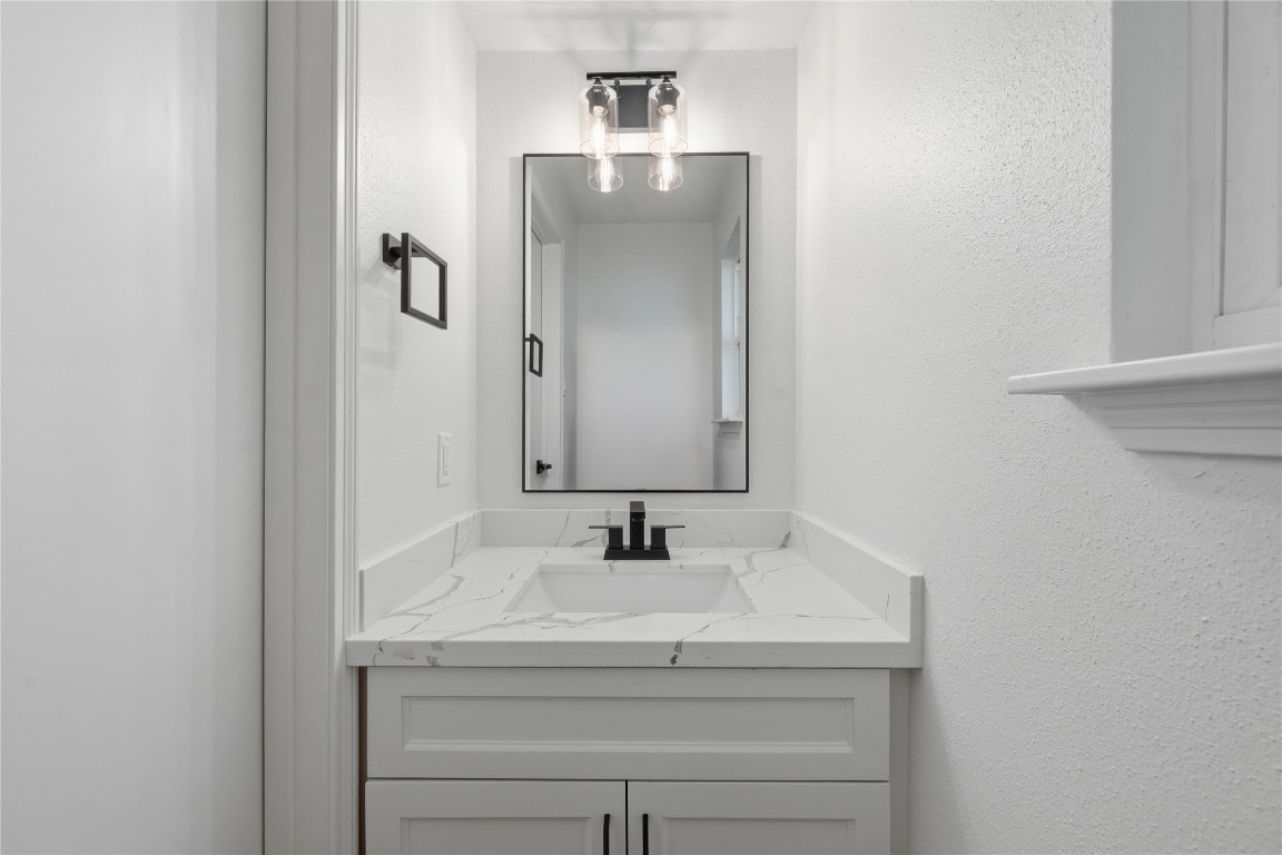 210 Ridgemont Drive Alvin, TX 77511 - Photo 21 of 25 a bathroom with a sink and a mirror