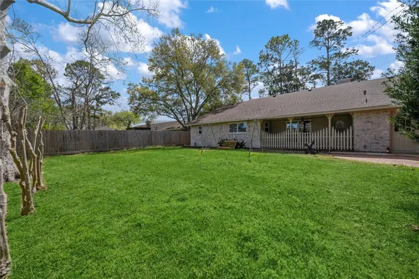a view of house that has a backyard