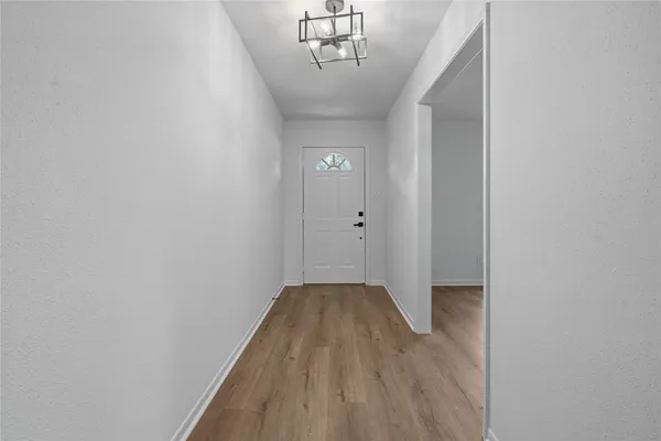 a view of a hallway with a chandelier