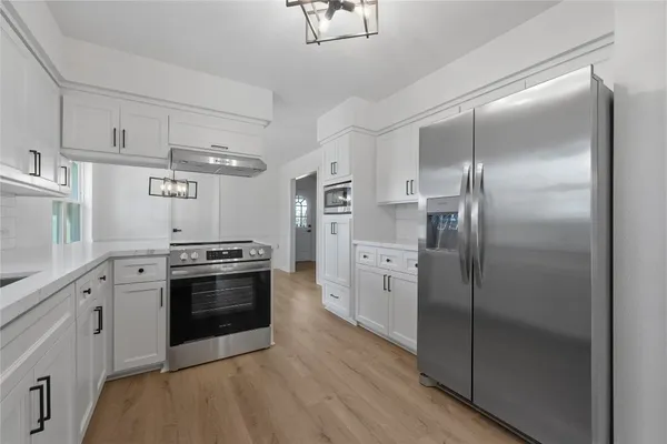 a kitchen with stainless steel appliances cabinets and a counter top