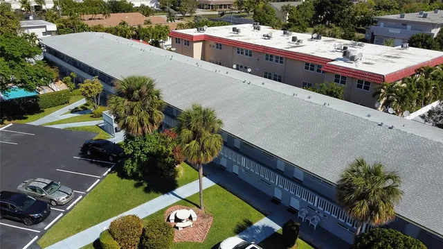 an aerial view of a house with a yard and garden