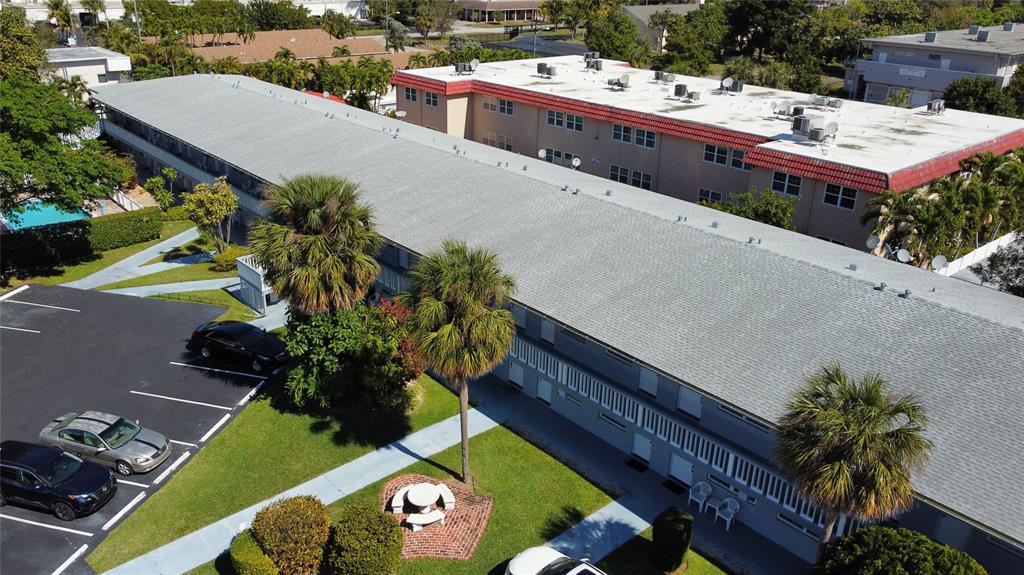 an aerial view of a house with a yard and garden
