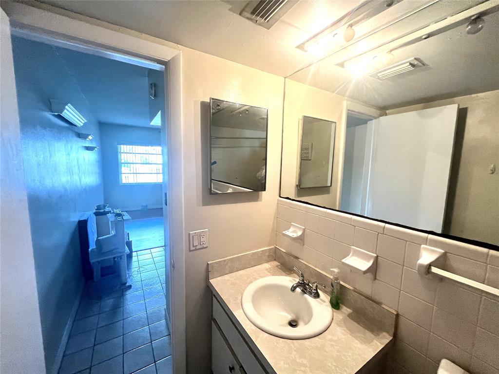 751 Pine Drive, Unit 103 Pompano Beach, FL 33060 - Photo 15 of 18 a bathroom with a sink a toilet and mirror