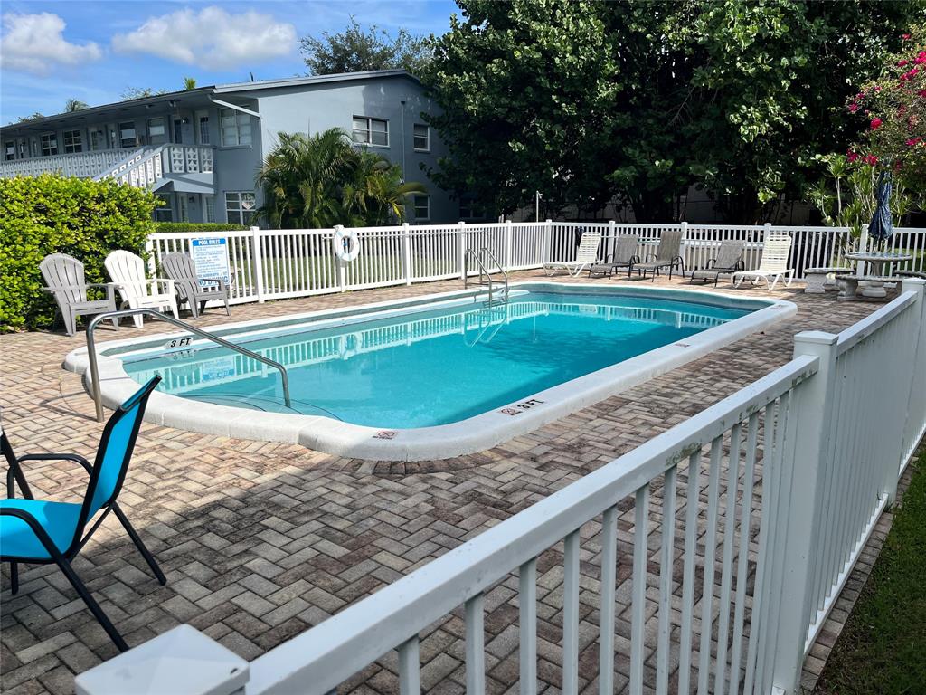 751 Pine Drive, Unit 103 Pompano Beach, FL 33060 - Photo 2 of 18 swimming pool view with a seating space