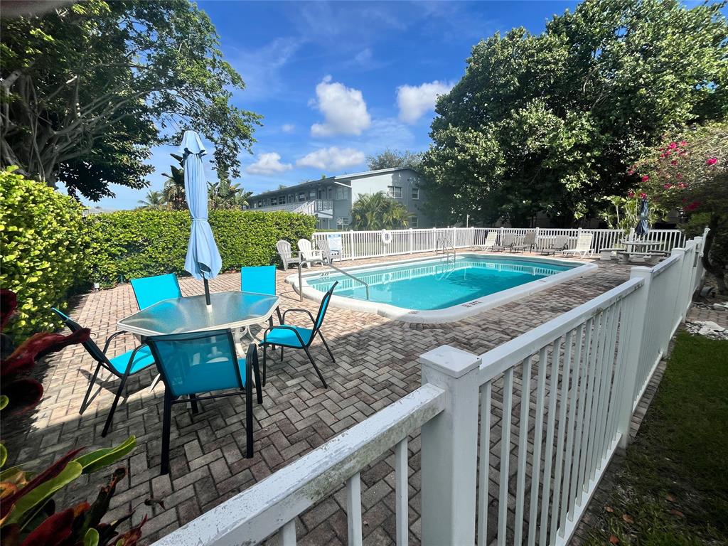 751 Pine Drive, Unit 103 Pompano Beach, FL 33060 - Photo 5 of 18 a view of a chairs and table on the terrace