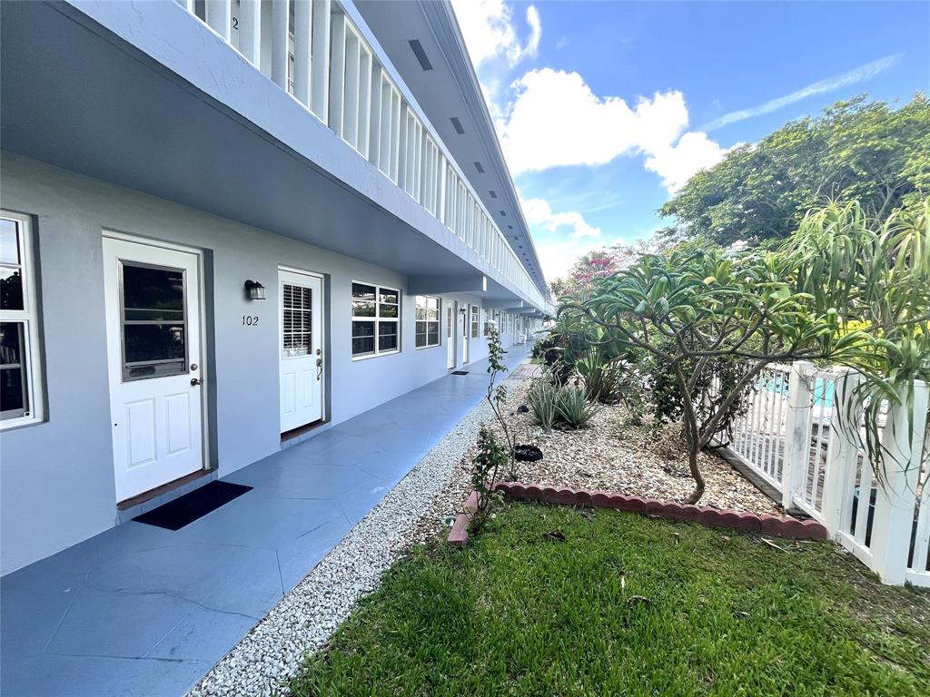 751 Pine Drive, Unit 103 Pompano Beach, FL 33060 - Photo 6 of 18 a view of a house with a yard