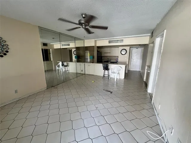 a view of a livingroom with furniture and a ceiling fan