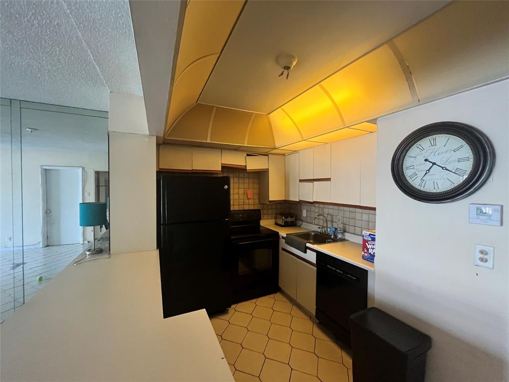 751 Pine Drive, Unit 103 Pompano Beach, FL 33060 - Photo 9 of 18 a kitchen with a refrigerator and a stove