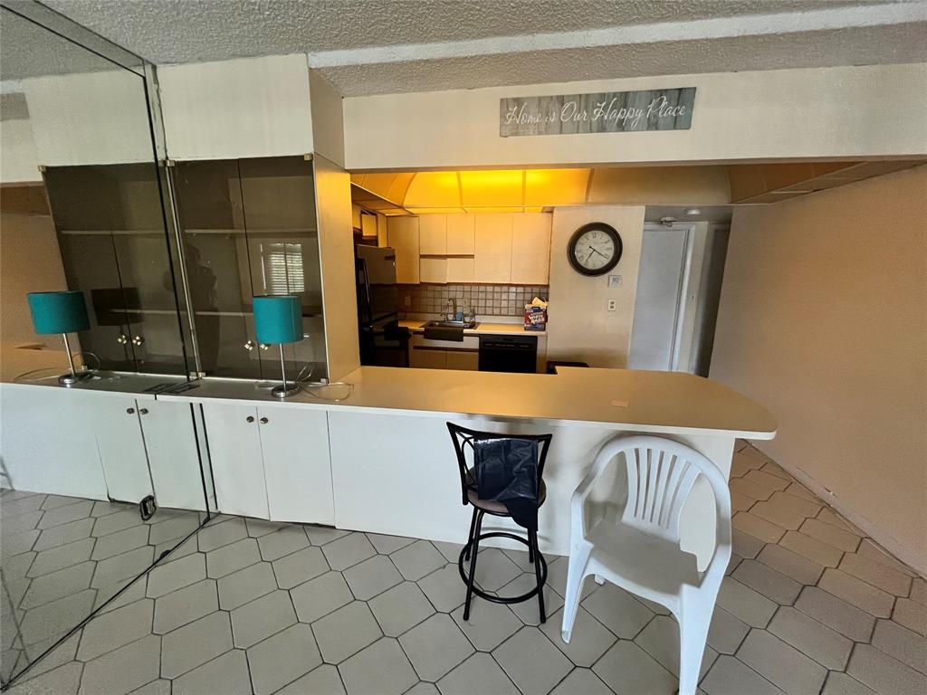 751 Pine Drive, Unit 103 Pompano Beach, FL 33060 - Photo 10 of 18 a view of a dining room with furniture and chandelier