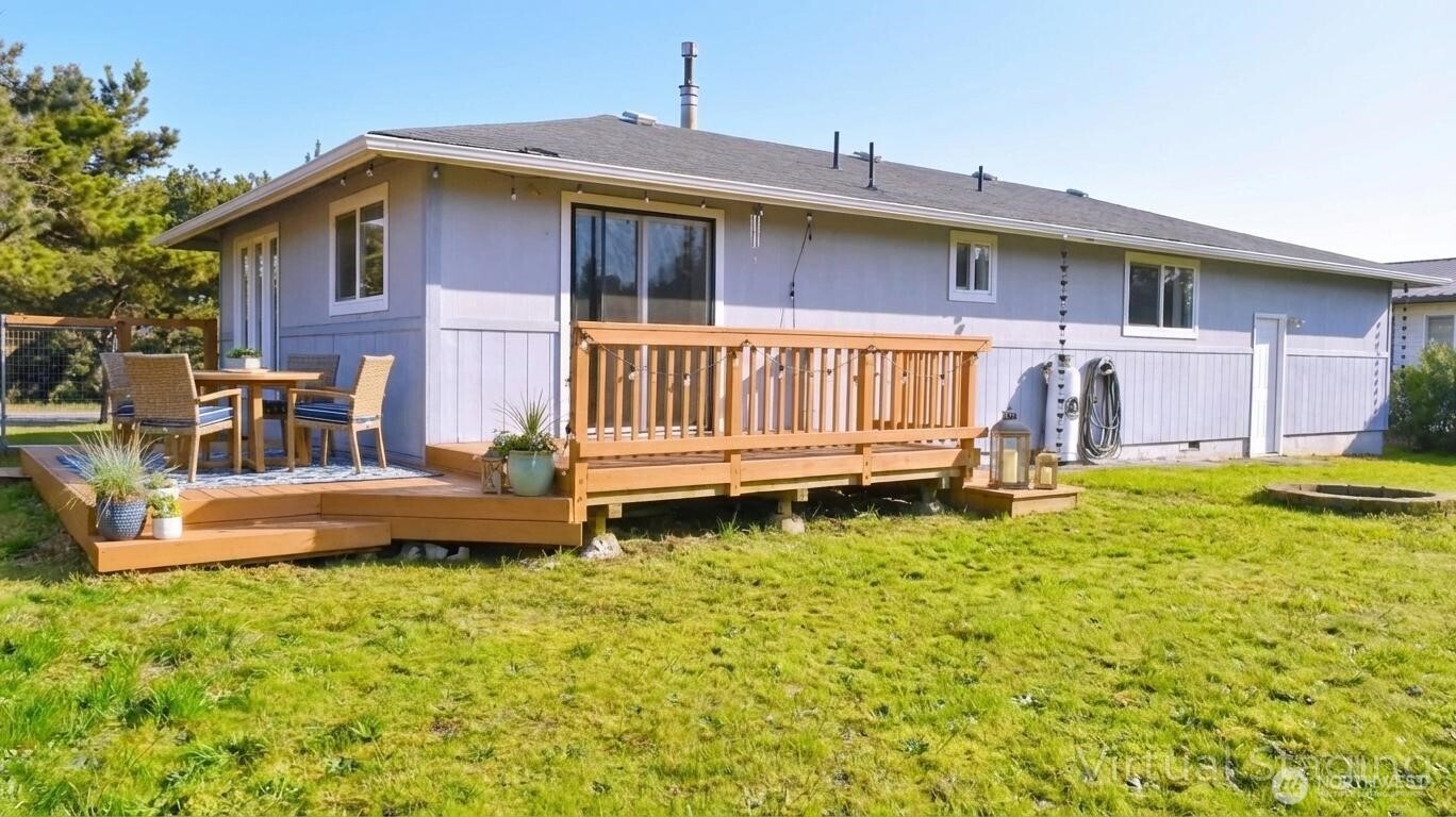 35102 H Place Ocean Park, WA 98640 - Photo 12 of 14 a front view of a house with a yard table and chairs