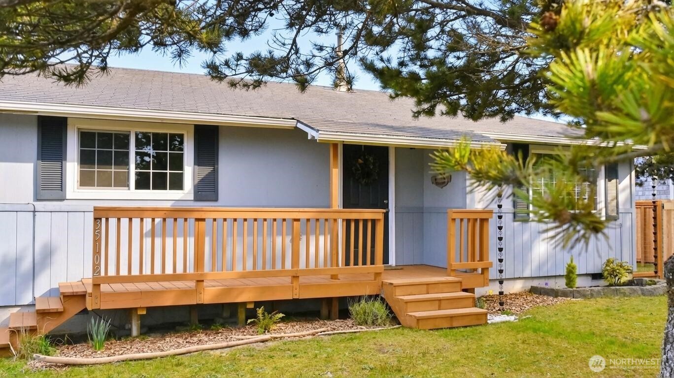 35102 H Place Ocean Park, WA 98640 - Photo 2 of 14 a backyard of a house with lake view and a potted plant