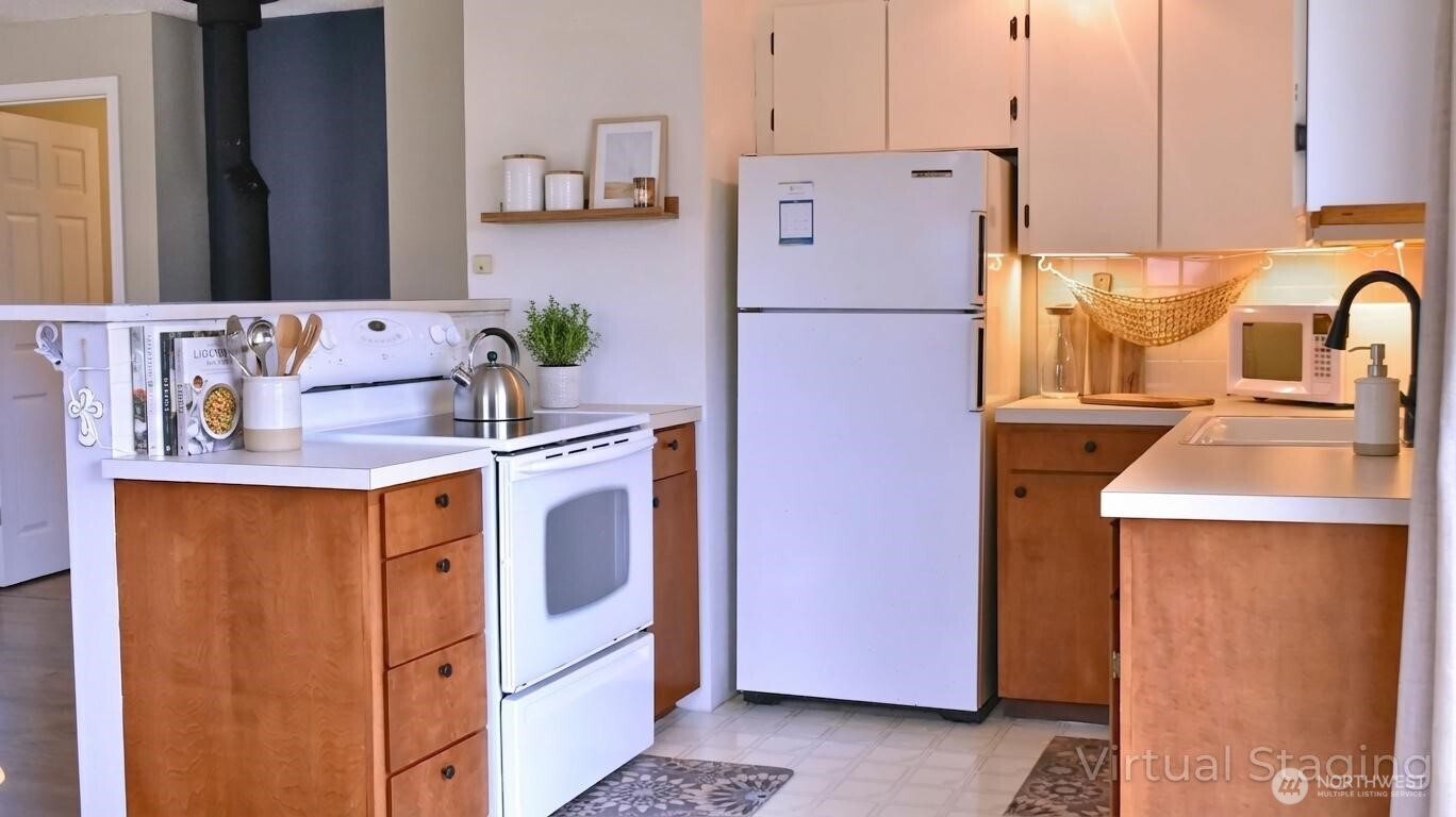 35102 H Place Ocean Park, WA 98640 - Photo 5 of 14 a kitchen with stainless steel appliances granite countertop a refrigerator a stove a sink and a refrigerator