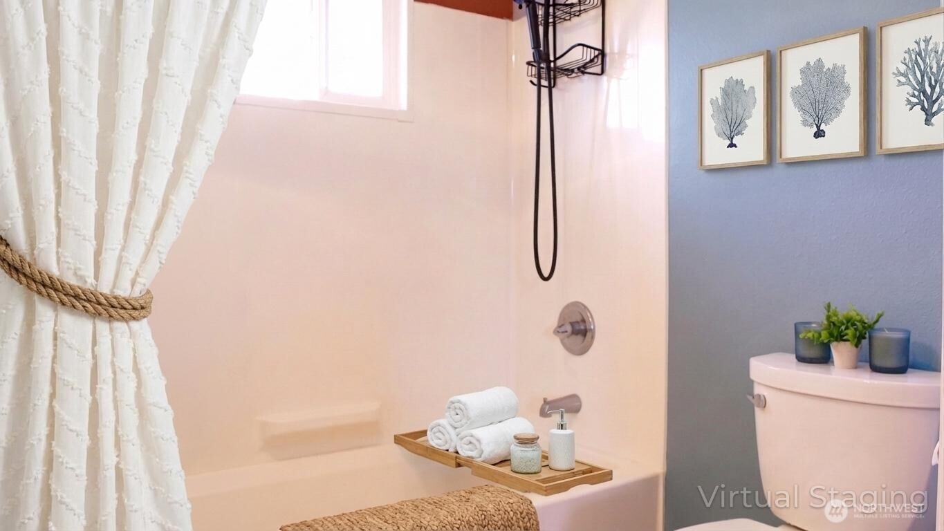 35102 H Place Ocean Park, WA 98640 - Photo 10 of 14 a bathroom with a toilet and a shower curtain