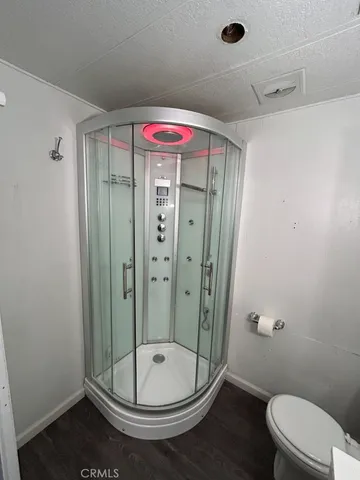 a bathroom with a shower a toilet and a shower