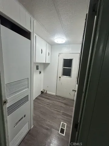 a view of a hallway with wooden floor