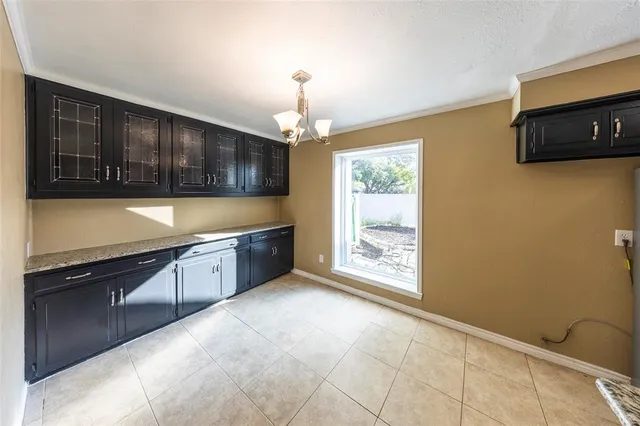 a kitchen with stainless steel appliances wooden cabinets a stove top oven a sink and dishwasher