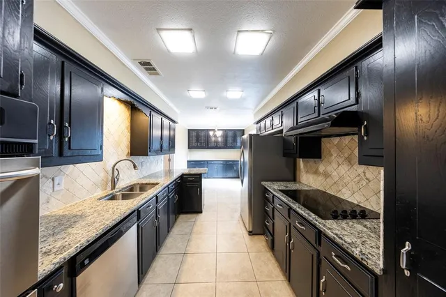 a kitchen with granite countertop stainless steel appliances lots of counter top space