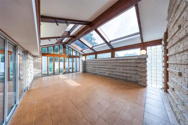 a view of an empty room with a staircase