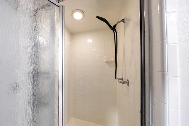 a bathroom with a glass shower door