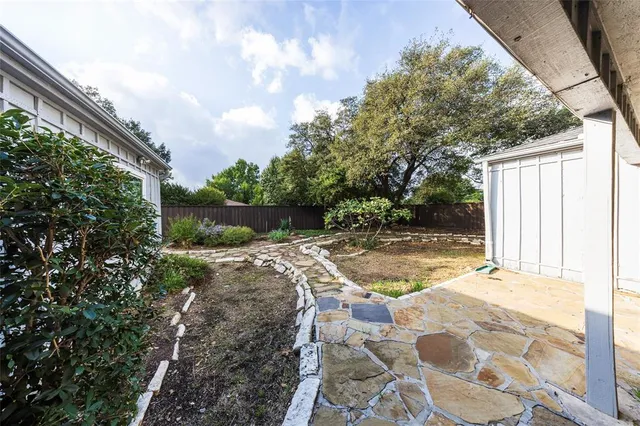 a view of a backyard with large trees