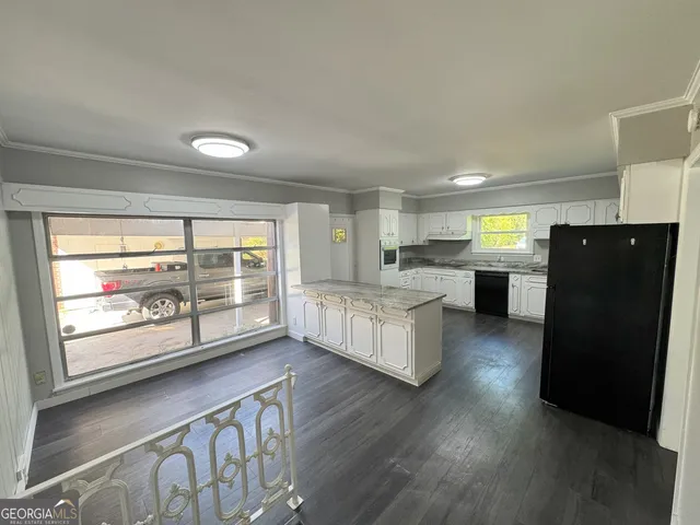 a kitchen with stainless steel appliances wooden floors and wooden cabinets
