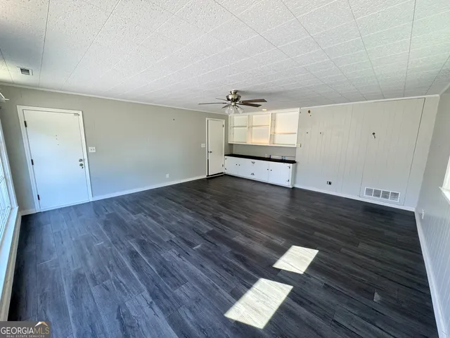 an empty room with wooden floor
