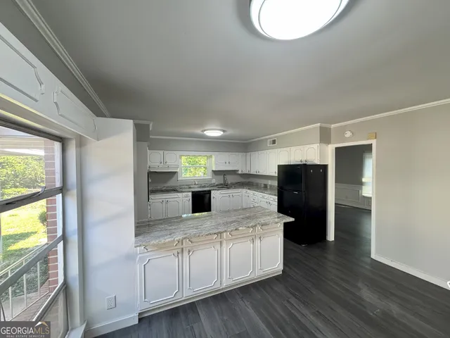 a kitchen with stainless steel appliances granite countertop a refrigerator and a sink