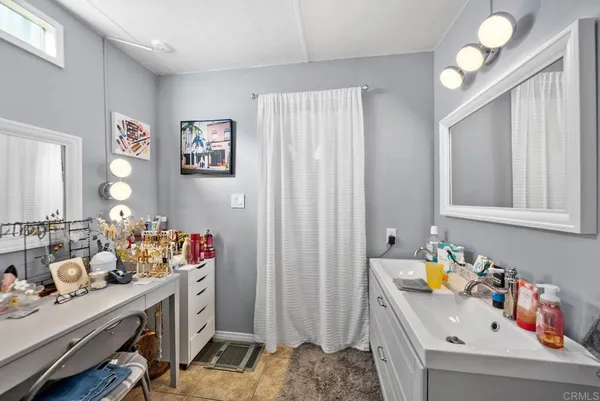 a bathroom with a sink mirror and vanity