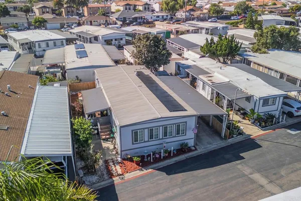 an aerial view of a house with a yard
