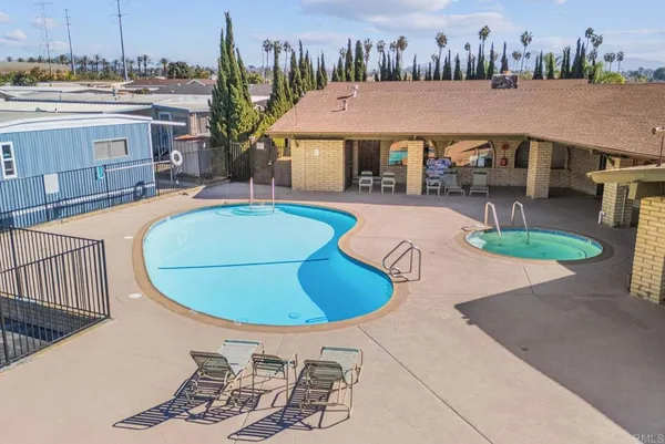 swimming pool view with a seating space