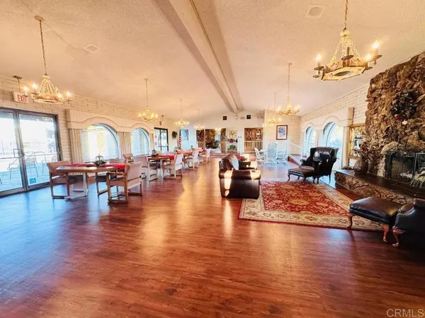 a living room with lots of furniture and kitchen view