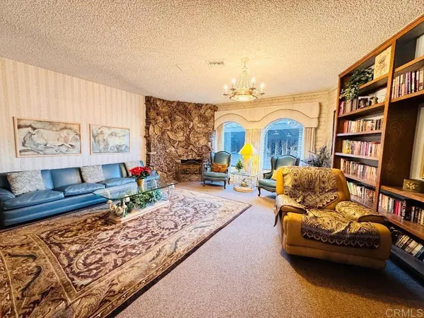 a bedroom with furniture and a book shelf