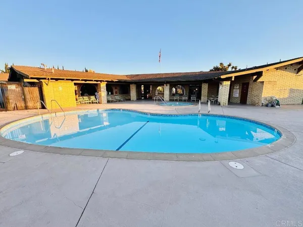 a view of a swimming pool with a patio