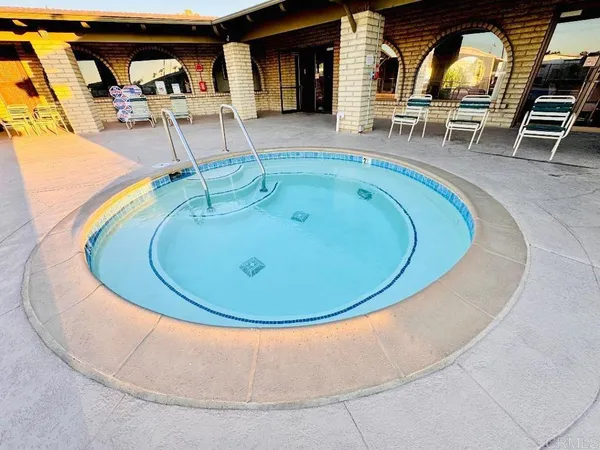 an aerial view of a house with swimming pool and porch