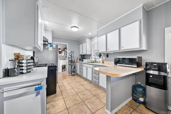 a kitchen with stainless steel appliances granite countertop a refrigerator sink and cabinets